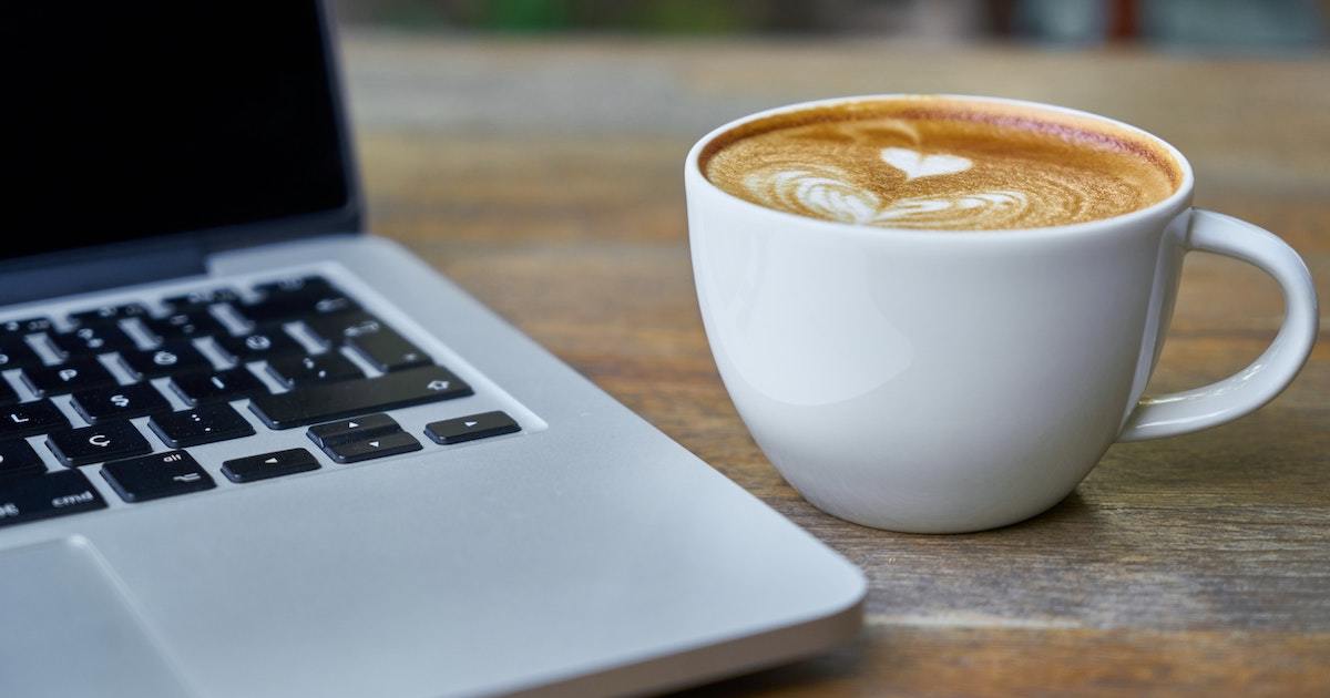 Image of a laptop next to a latte