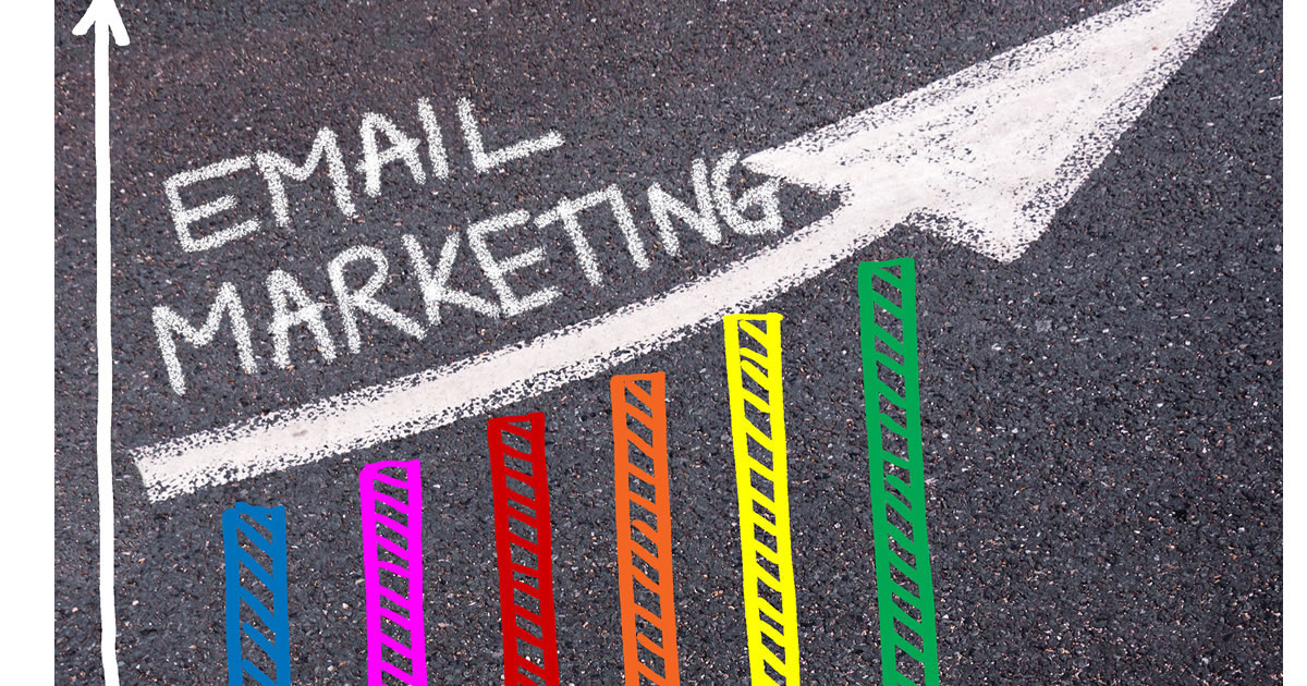 Pavement with the words email marketing written in chalk above arrow and bar graph