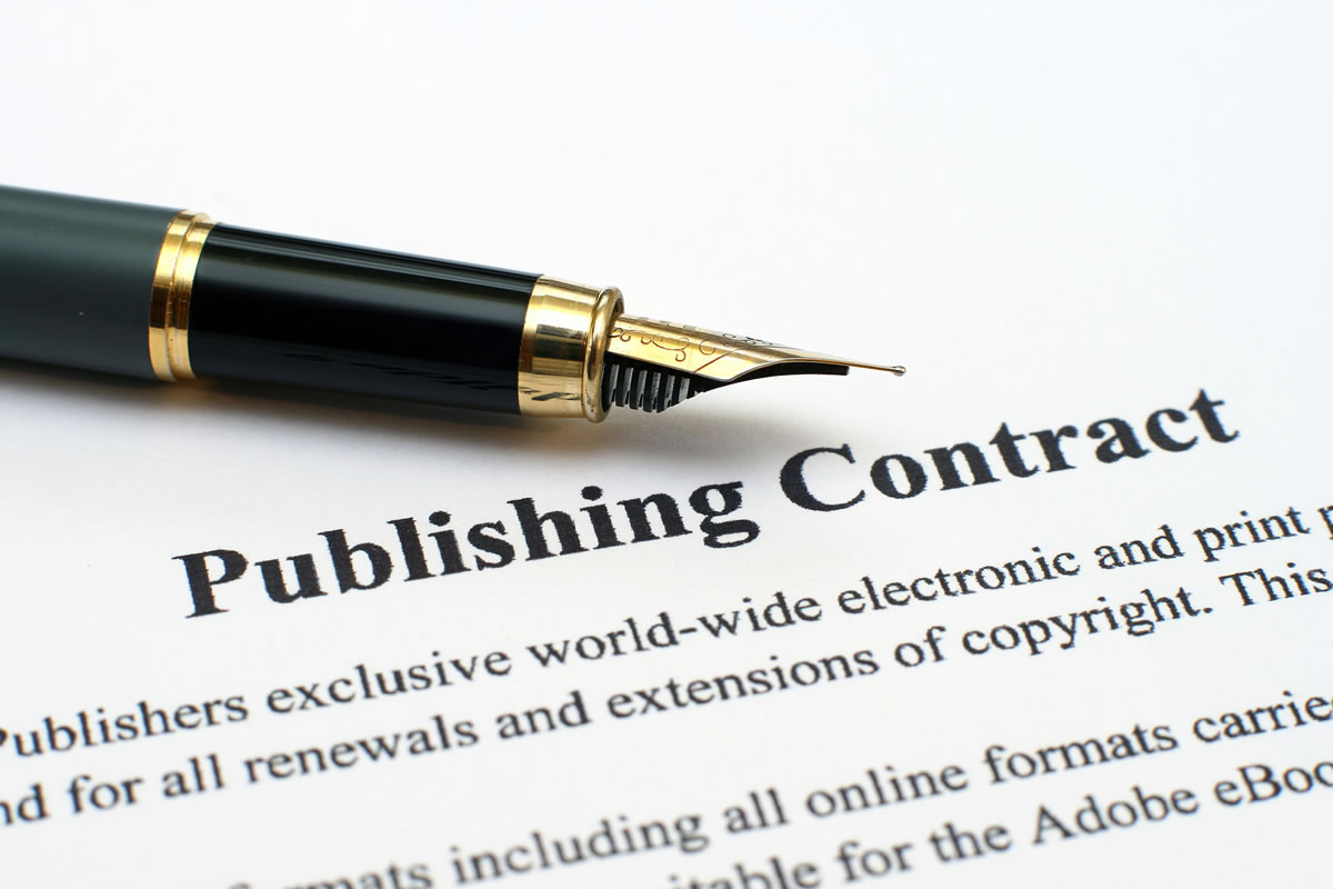 Fountain pen resting on paperwork with the words publishing contract