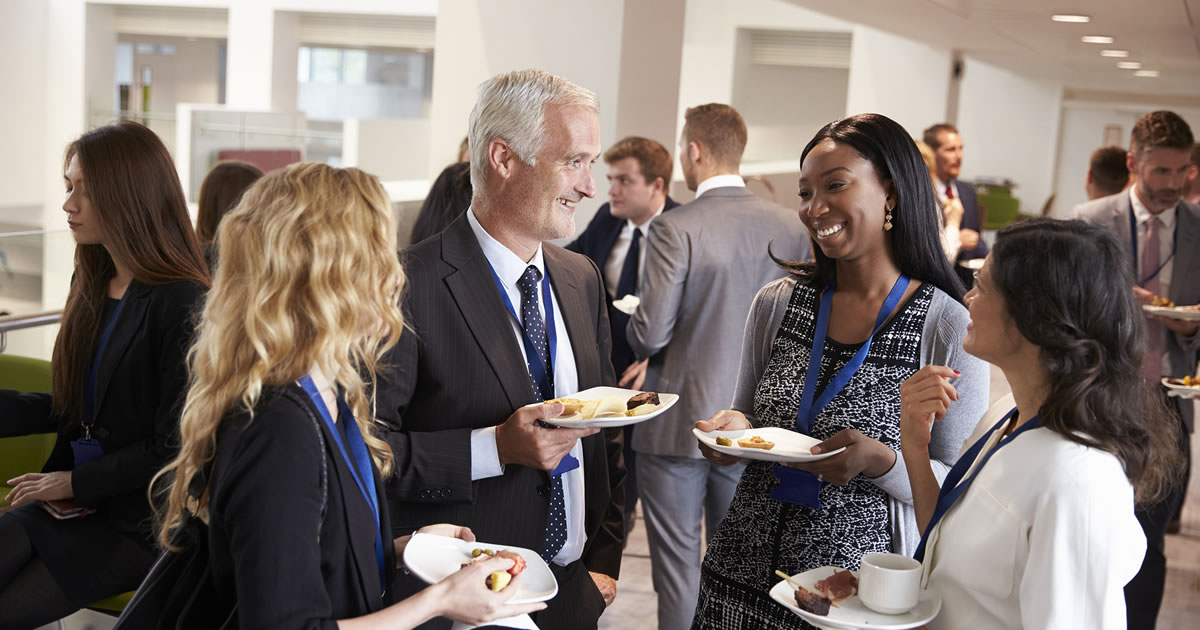 Group of business people talking at a networking event