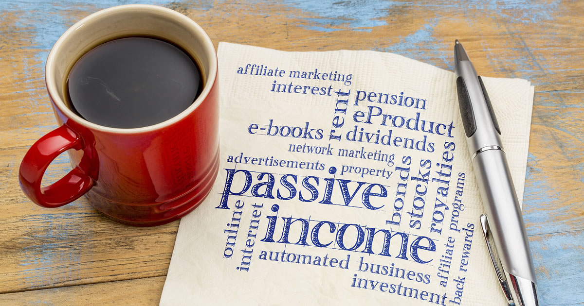 Passive income word cloud including affiliate marketing and e-books in handwriting on a napkin with a cup of coffee