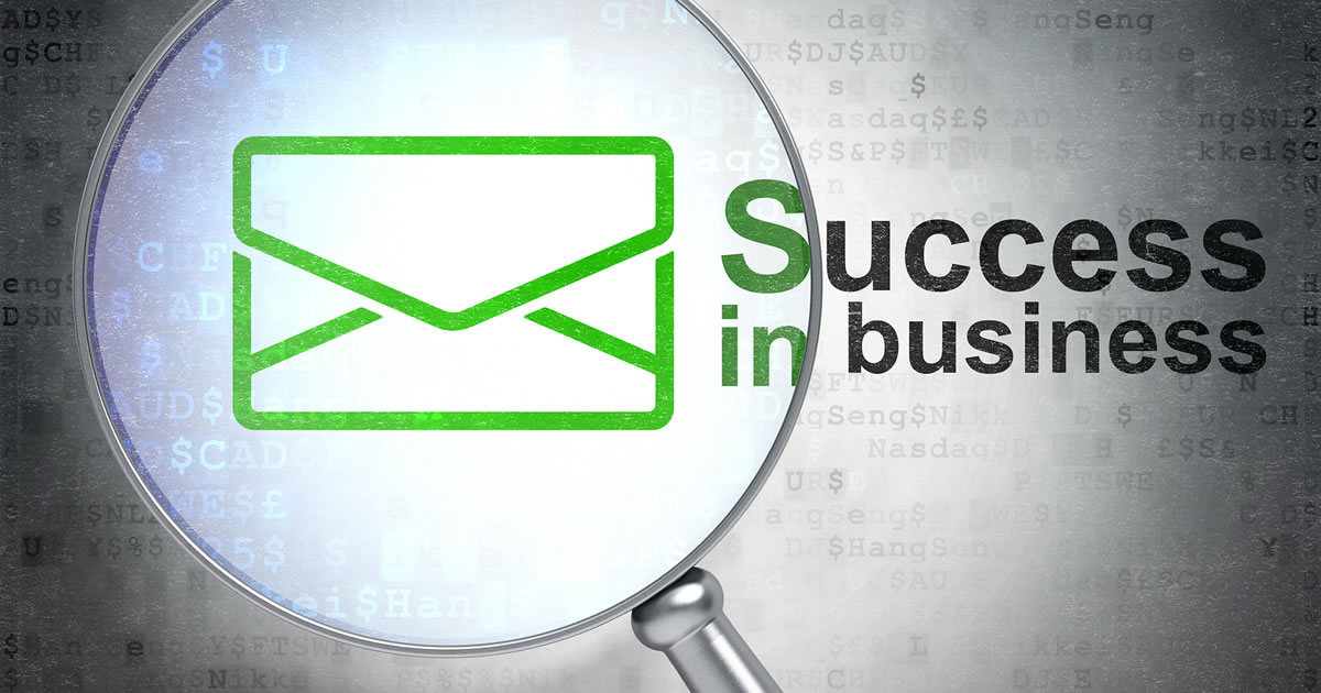 Email marketing icon under magnifying glass with written Success in Business