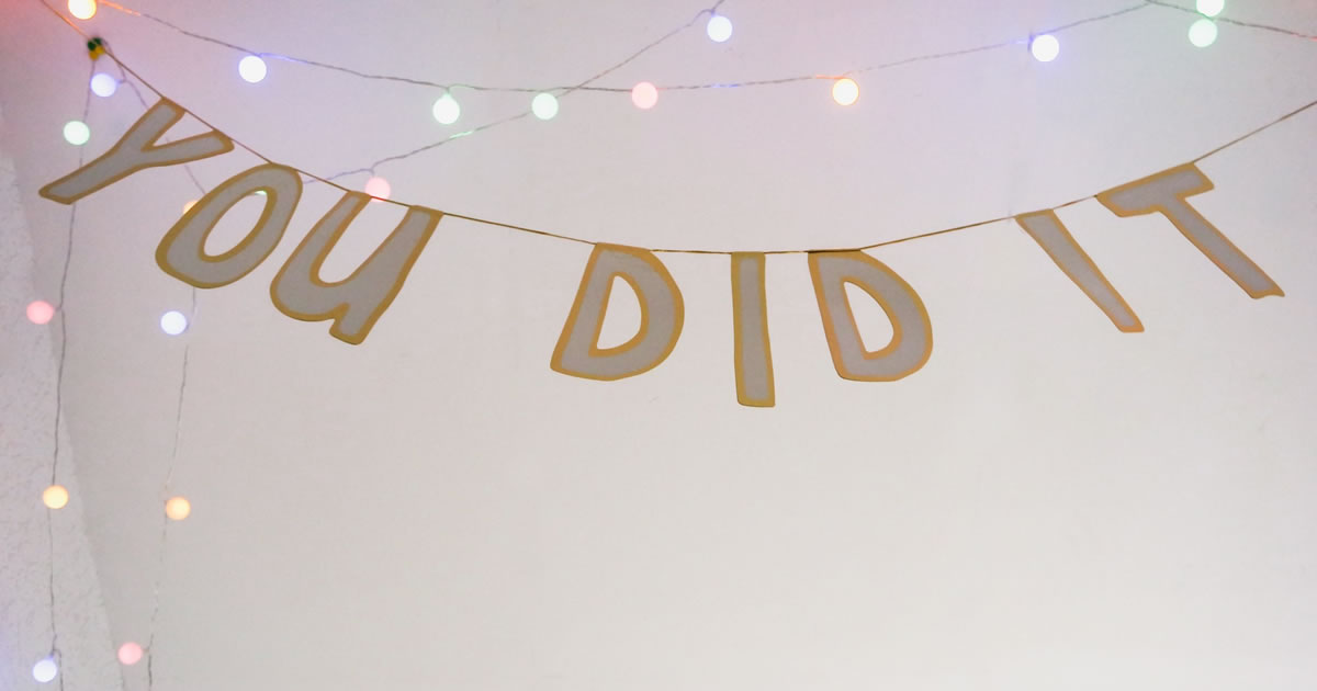 You Did It celebratory banner with string lights