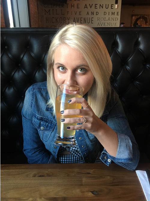 Photo of copywriter Allison Comotto drinking her favorite beer at her favorite Happy Hour spot