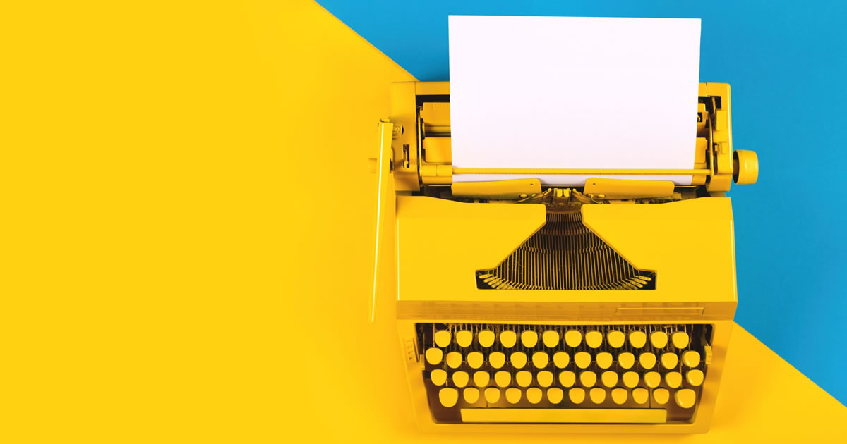 Yellow typewriter on yellow and blue background