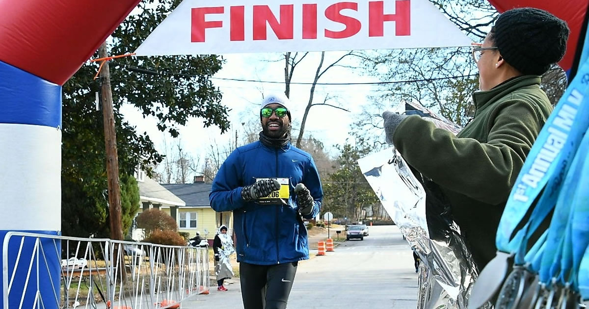 Smiling runner crossing the finish line