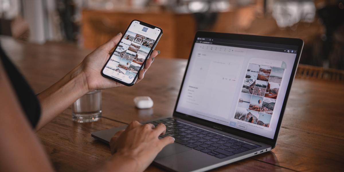 Woman looking at a website on her smartphone and laptop