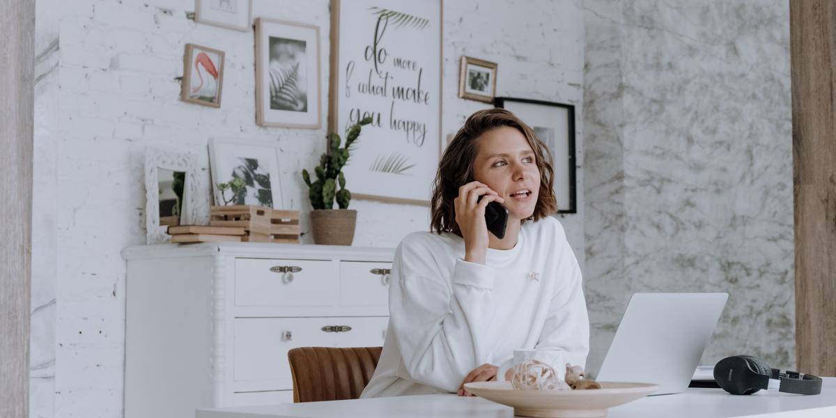 Young woman talking with a customer on the phone