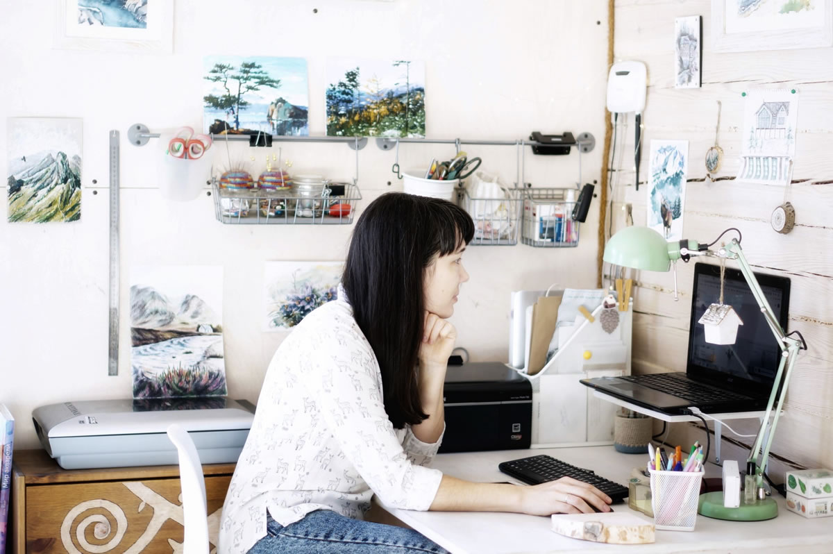 Woman at desk working on laptop