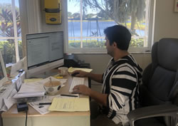 Writer Elias Christeas working at his desk at home.