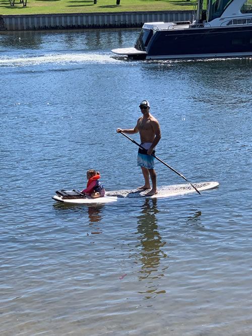 Writer Rob Gramer paddleboards with his daughter near their Florida home