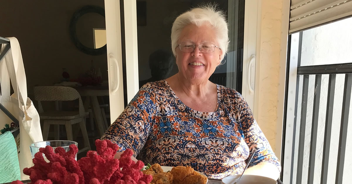 Writer Sally Morem dining on the balcony of her Florida condo
