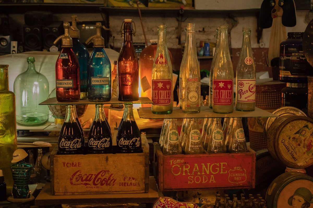 Assorted antique soda botles on a shelf
