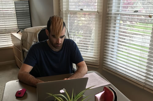 Writer Joey Lubelfeld working on laptop at home