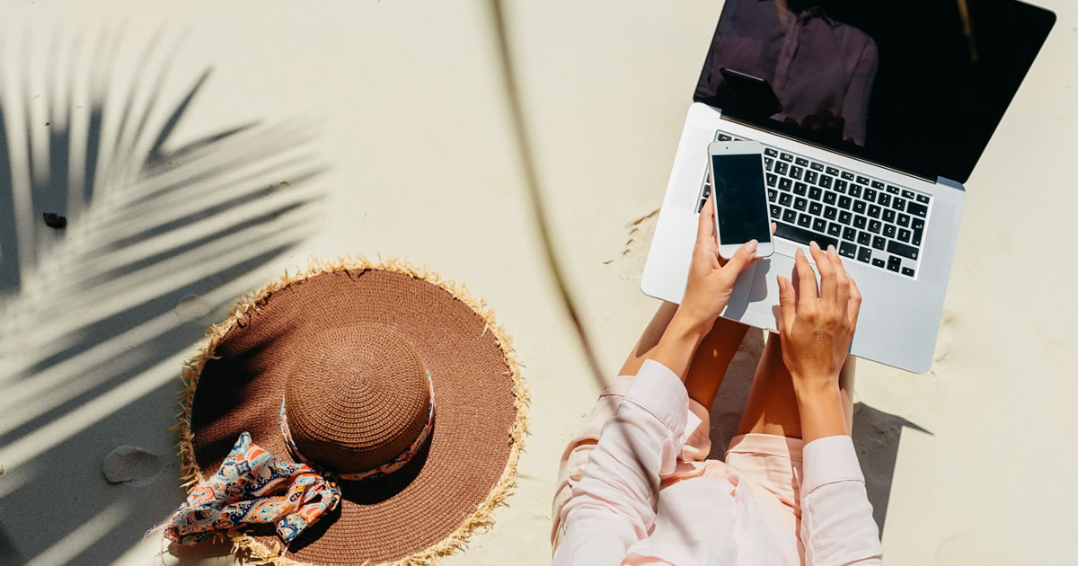 Woman freelance writer working on the beach