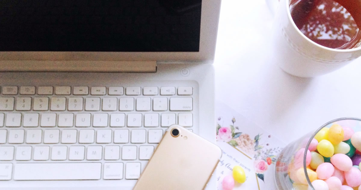 desk with candy and computer and smartphone