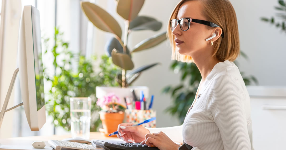 Focused businesswoman studying computer screen at desk