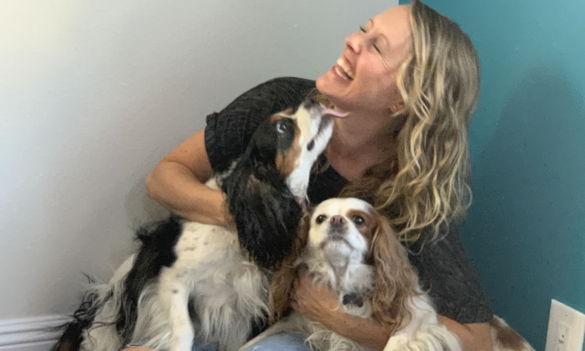 Barefoot Writer Mindy McHorse playing with two dogs
