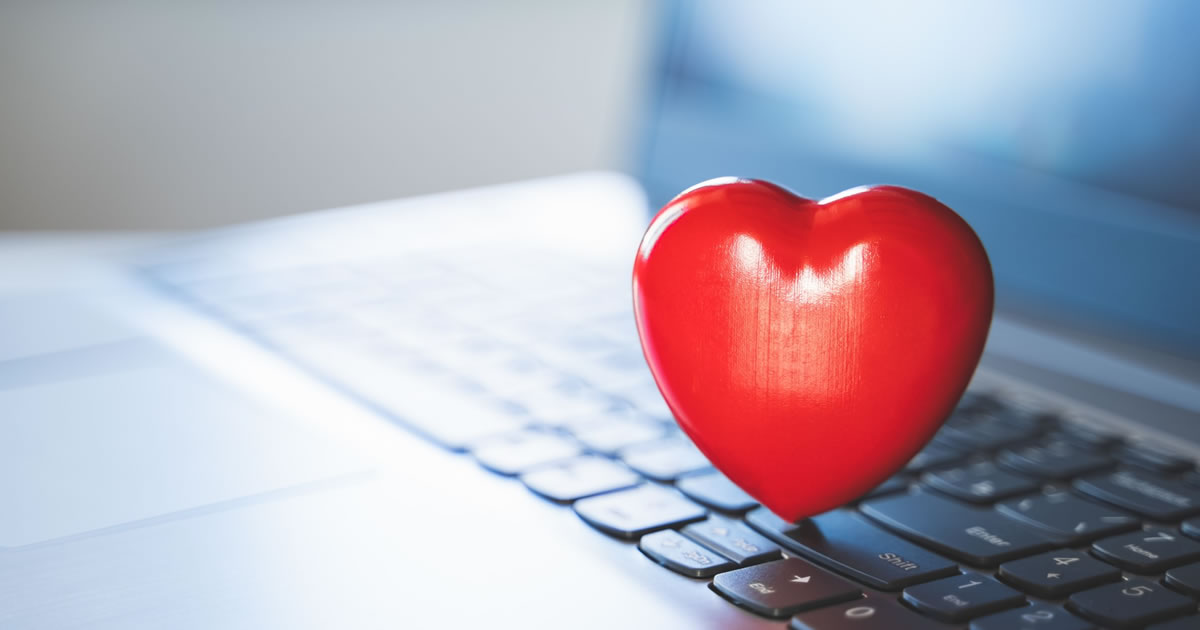 Writing for good: big red heart on laptop keyboard