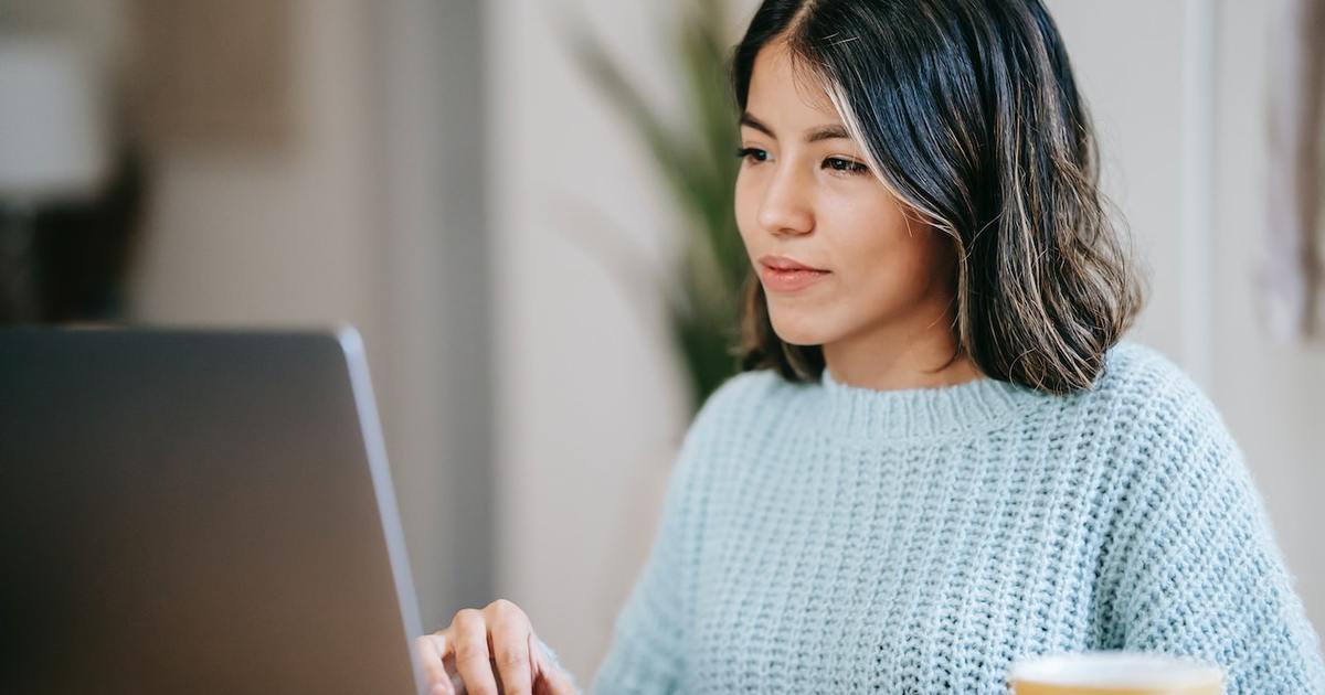 female writer using AI tools on laptop