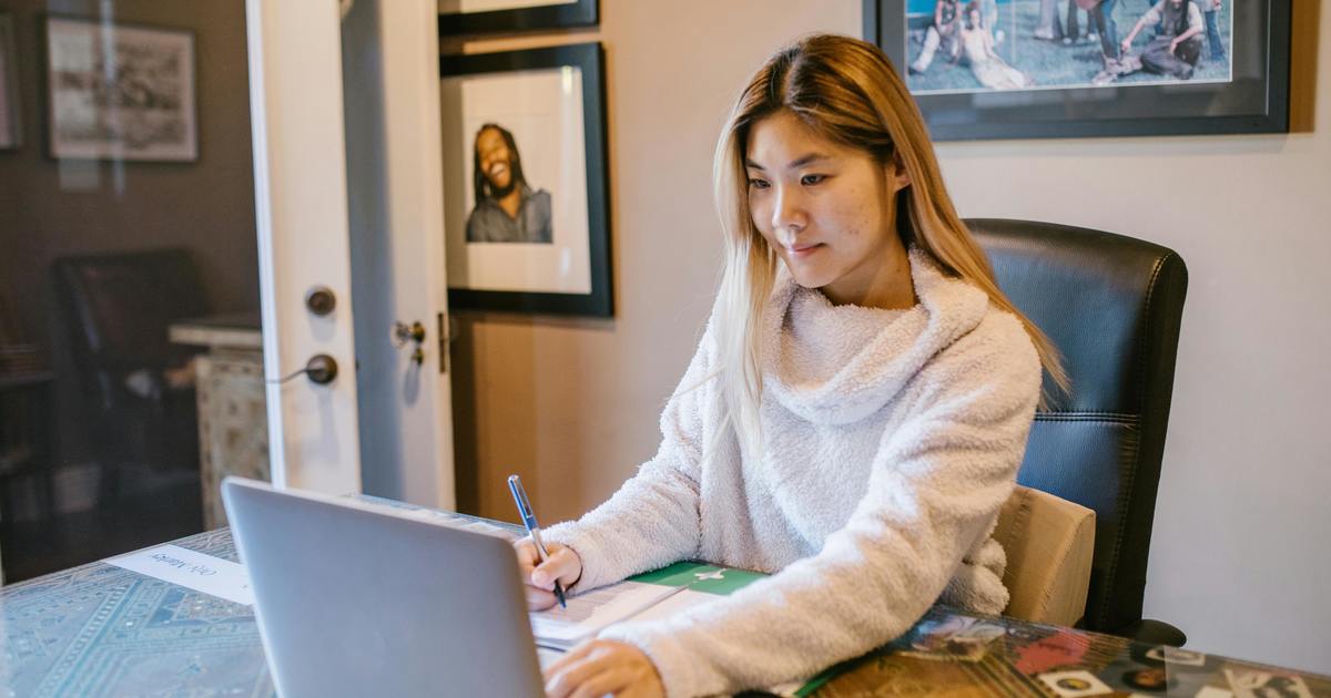 Writer typing on a laptop