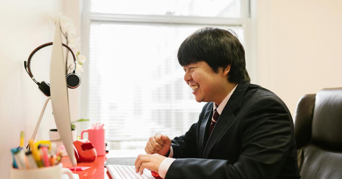 Writer typing on laptop at desk