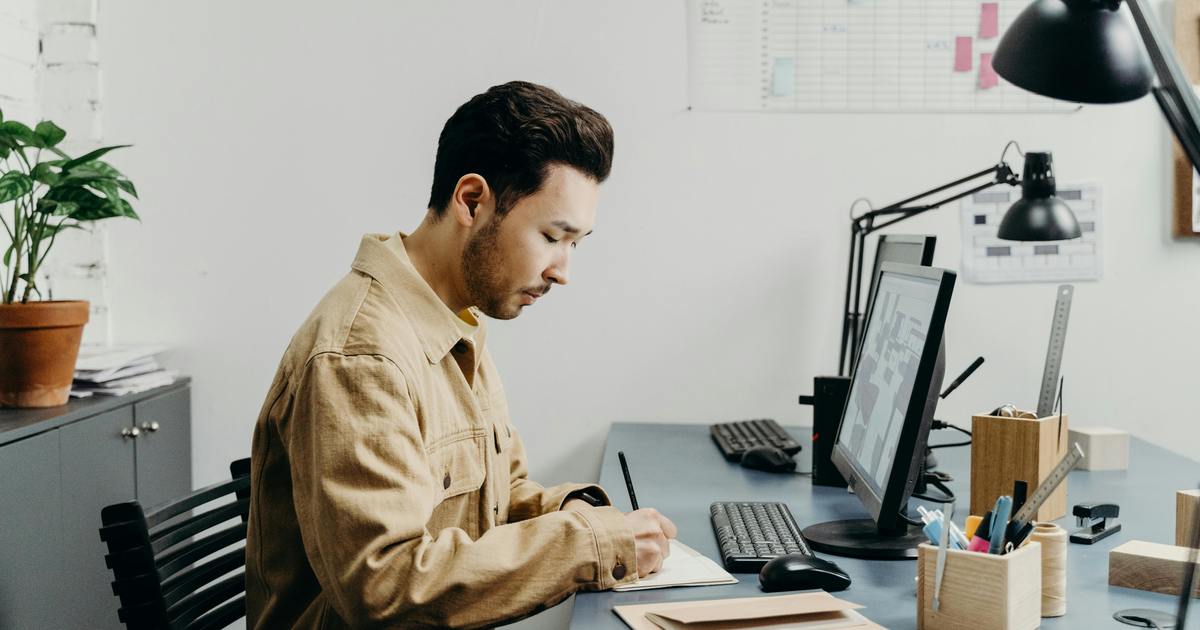 Writer typing on laptop at desk