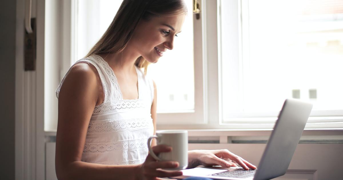 Happy woman smiling with laptop