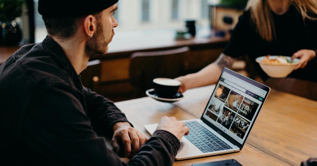 Writer working from a coffee shop with laptop