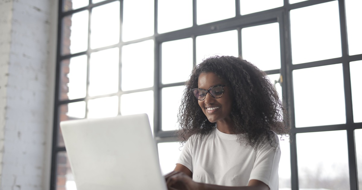 Writer sitting at table typing on laptop