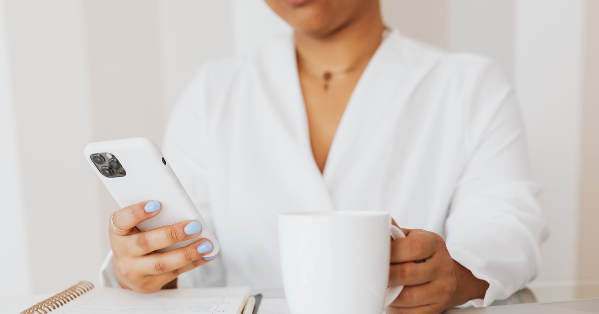 Woman reading a newsletter on her phone