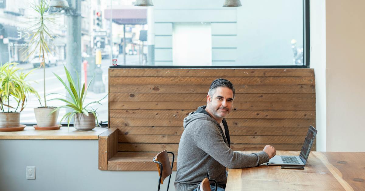 Writer smiling with laptop