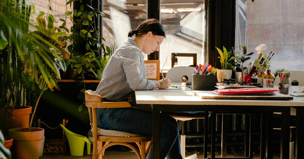 Writer sitting at a table taking notes