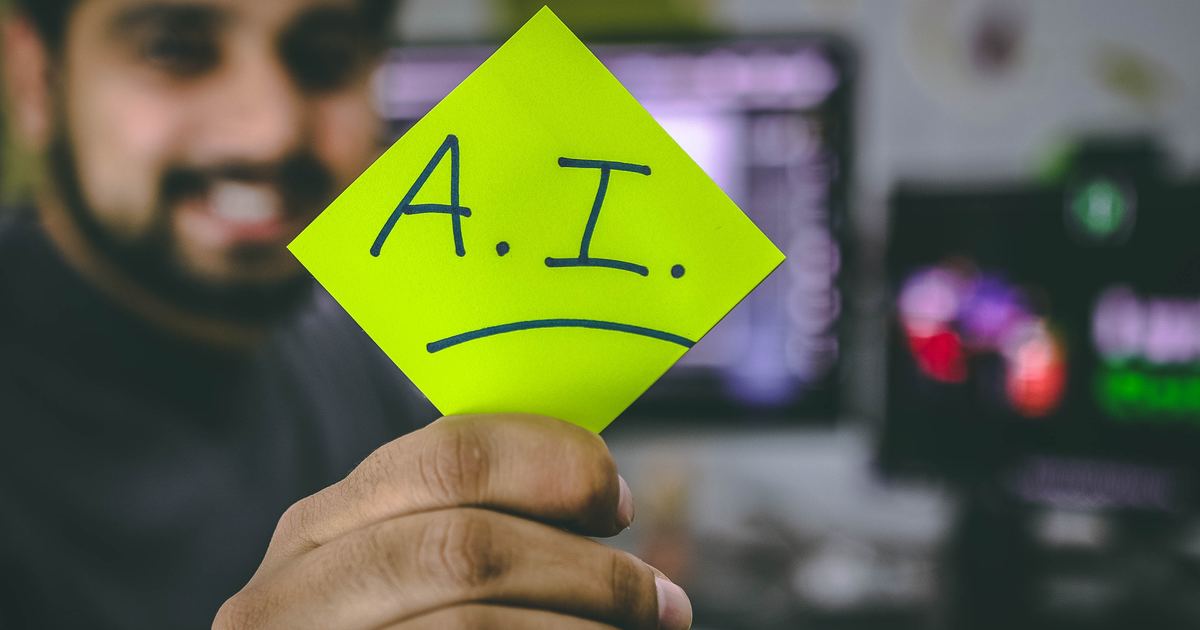 Happy guy holding AI sign