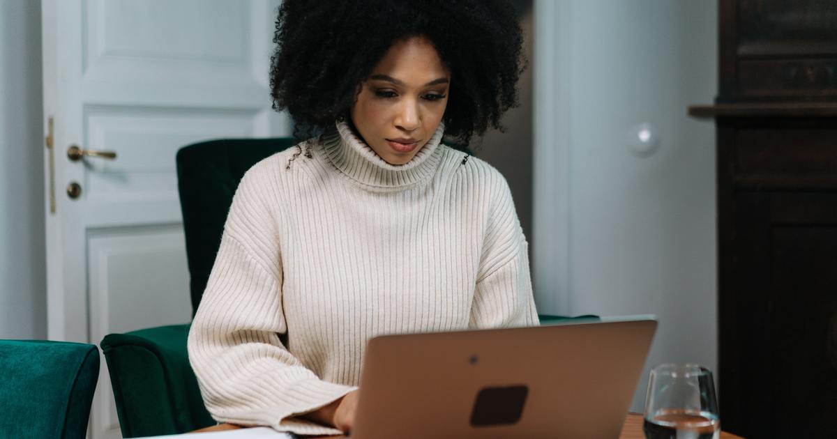 Writer typing on a laptop at a table