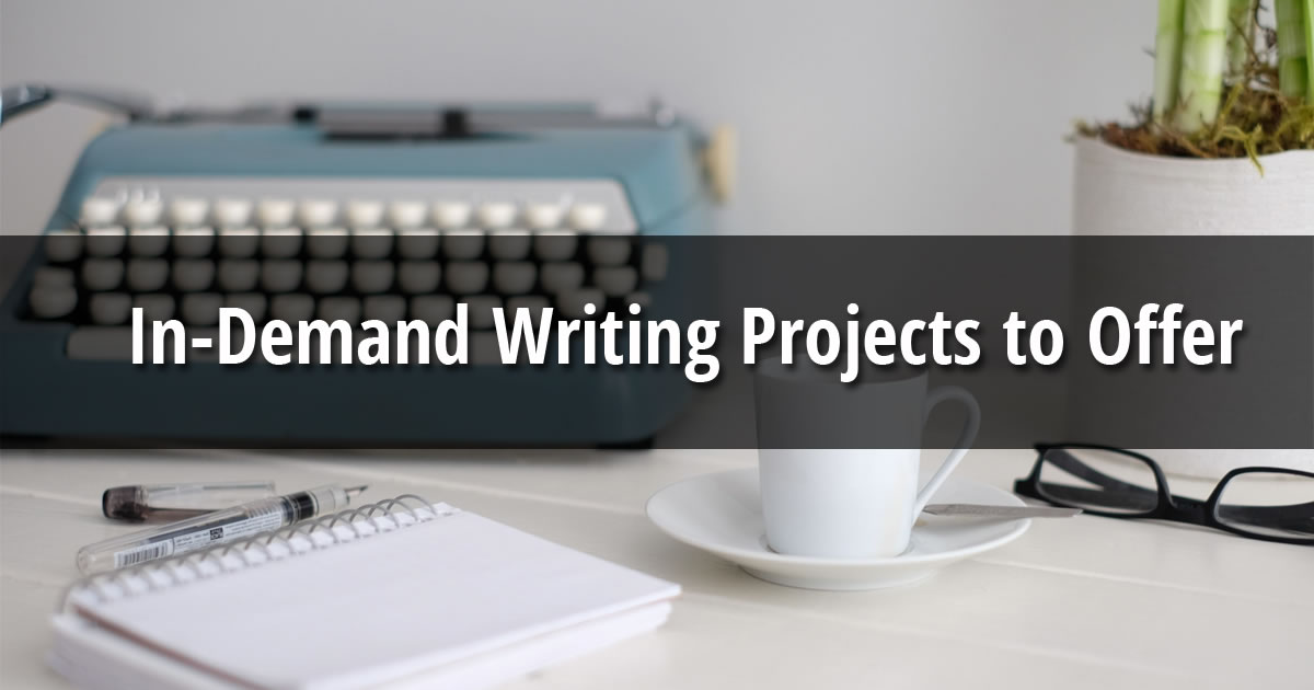 Typewriter, notepad, pen, cup and saucer, eyeglasses, and plant on a desk with text overlay of the words Just Announced In-Demand Writing Projects to Offer