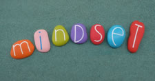 Smooth colorful rocks spelling out the word mindset
