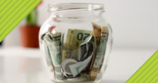 Closeup of glass jar filled with cash