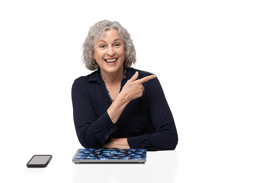 Pam Foster sitting at a desk pointing to the right