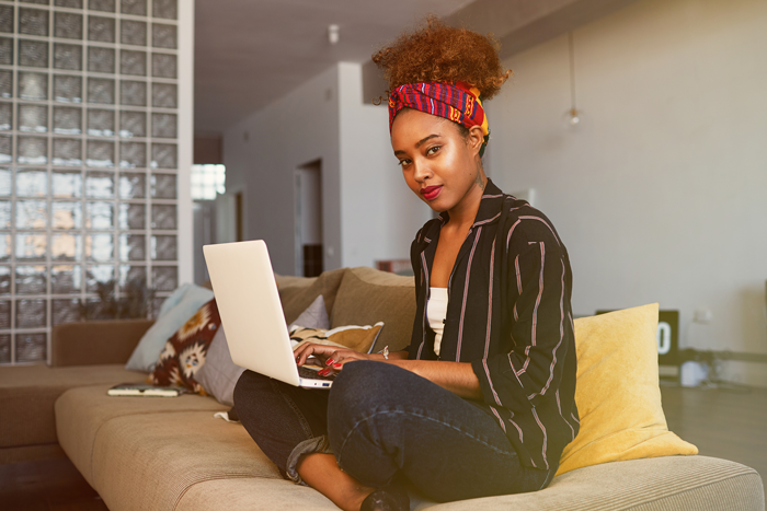 Copywriter working on her laptop at home